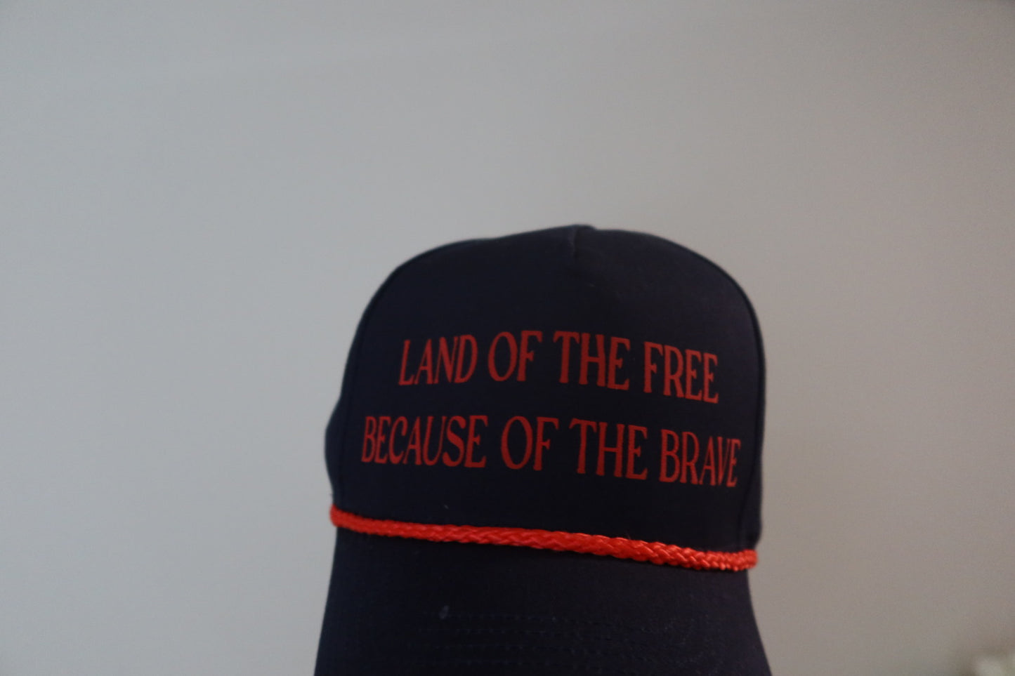 LAND OF THE FREE BECAUSE OF THE BRAVE-NAVY AND RED HAT