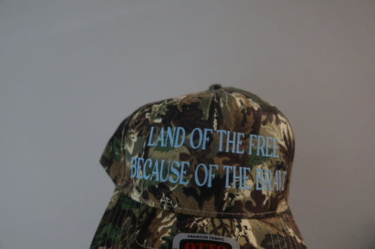 LAND OF THE FREE BECAUSE OF THE BRAVE-CAMO WITH BLUE HAT