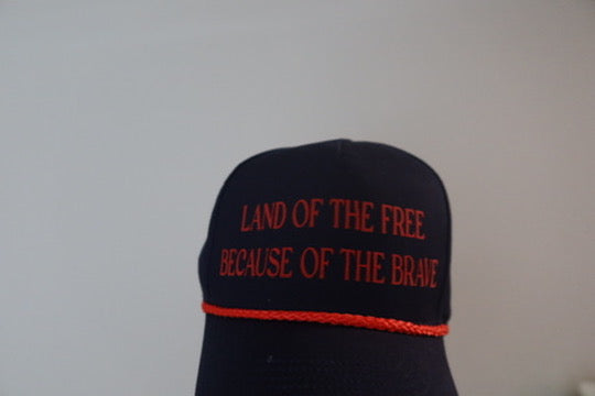 LAND OF THE FREE BECAUSE OF THE BRAVE-NAVY AND RED HAT